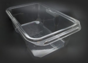 A clear plastic container with a lid on a black background.