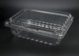 A clear plastic container with a lid on a black surface.