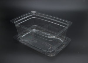 A clear plastic container with a lid on a black background.