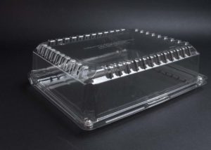 A clear plastic box on a black surface.