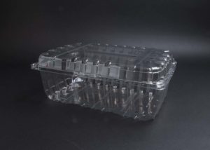 A clear plastic container on a black surface.