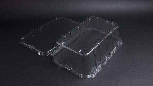 A clear plastic container on a black surface.