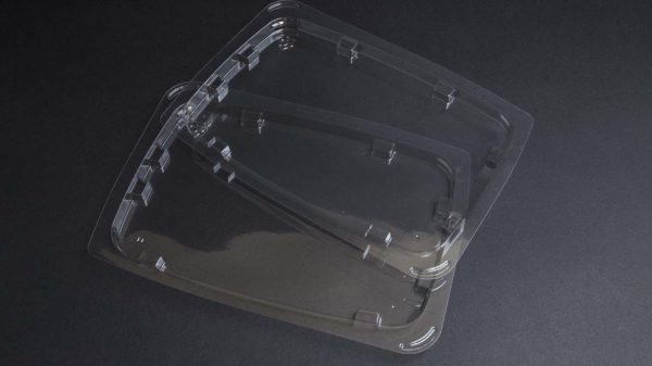 Two clear plastic containers on a black surface.